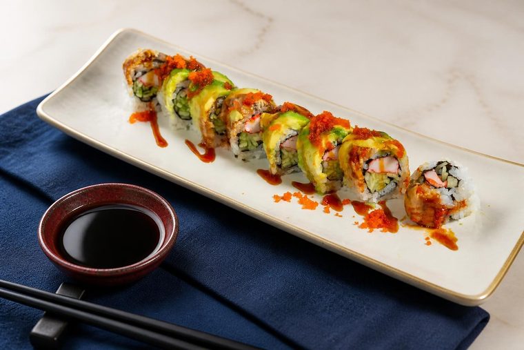 A roll topped with avocado and capelin roe